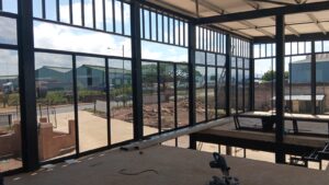 Interior view of large aluminium-framed glass curtain wall under installation by 3MC Services KZN